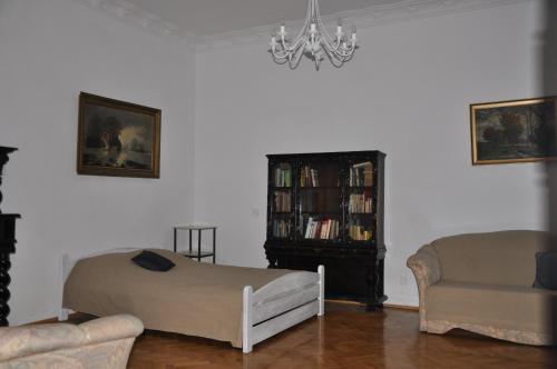 a living room with a bed and a book shelf at Apartament Sopot Andre in Sopot