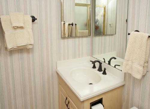 a bathroom with a sink and a mirror and towels at All Seasons G4 Condo in Vail
