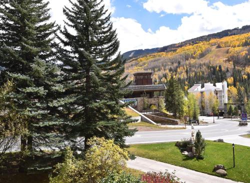 a building with trees in front of a street at Vantage Point #209 Condo in Vail