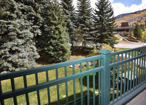 a blue fence on a balcony with trees at Vantage Point #209 Condo in Vail