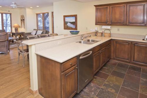 a kitchen with wooden cabinets and a sink at Aspenwood Lodge #201 Condo in Edwards