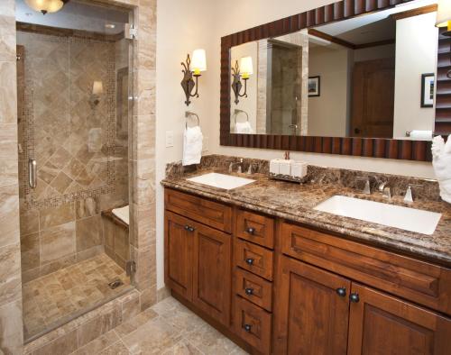 a bathroom with two sinks and a shower at Ritz Carlton Residence Vail #112 Condo in Vail