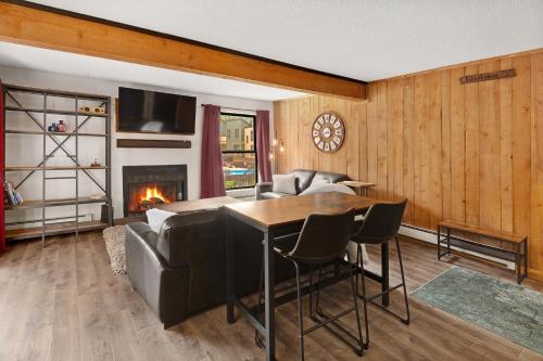 a living room with a couch and a table and a fireplace at Breakaway West #212 condo in Vail