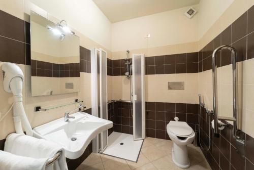 a bathroom with a sink and a toilet and a shower at Hotel San Giuan in Alghero