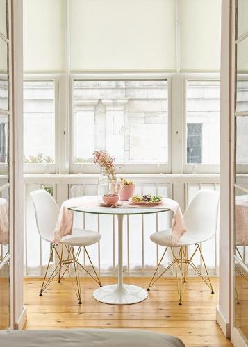 a dining room with a white table and chairs at Urban Suite Santander in Santander