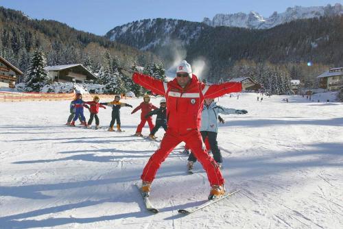 a group of people on skis in the snow at Appartamento Puez in Selva di Val Gardena