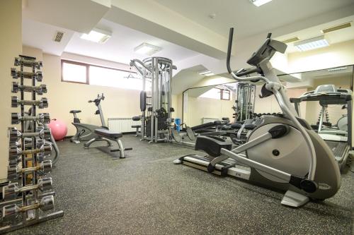 a gym with treadmills and exercise equipment in a building at Parklands Hotel & Pool in Bansko