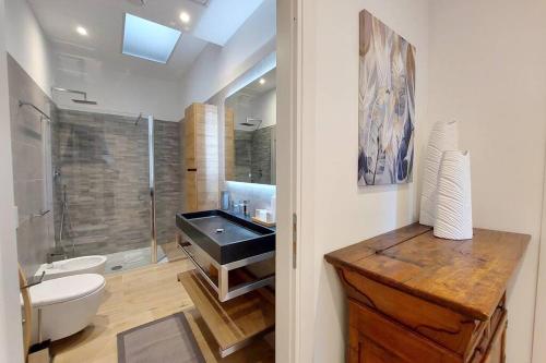 a bathroom with a sink and a toilet and a shower at Aventino Contemporary Apartment in Rome