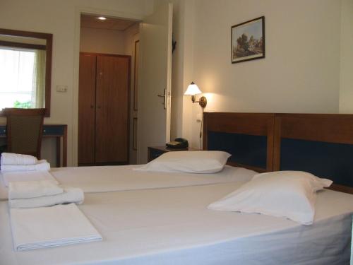a bedroom with two beds with white pillows at Aiolos in Loutra Edipsou