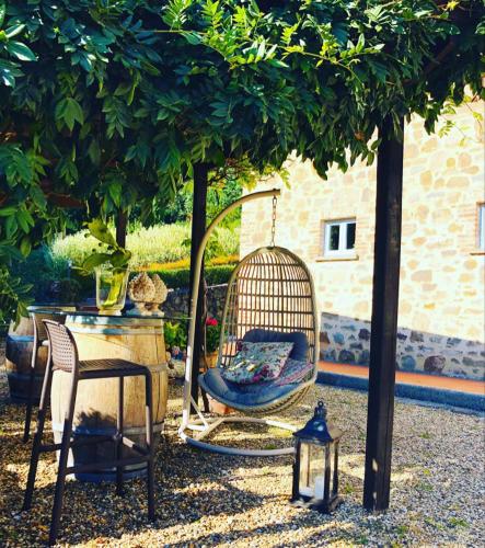 a swing in a yard under a tree at Il Borghetto Andrea Tafi in Lamporecchio