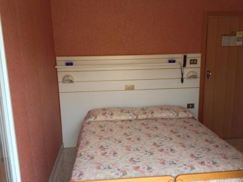 a small bedroom with a bed in a room at Hotel Emma Nord in Rimini