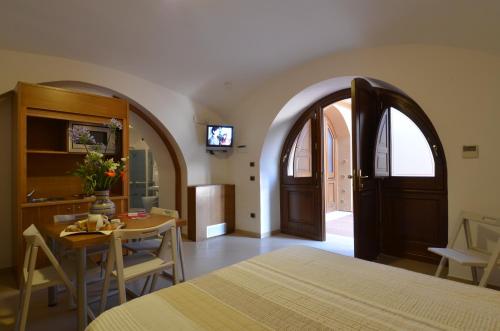 a bedroom with a bed and a table and a television at Hotel Zeus in Pompei