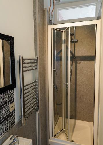 a shower with a glass door in a bathroom at Southville Guest House in Weymouth