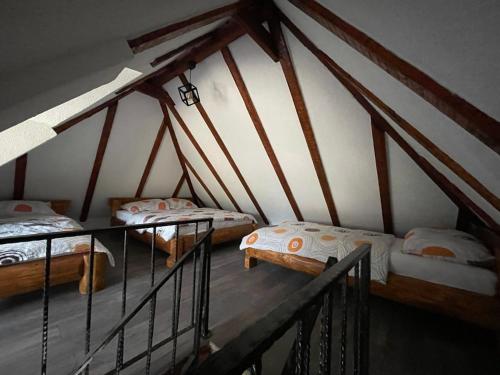 a room with three beds in a attic at Apartmani Nišićka Oaza in Sarajevo