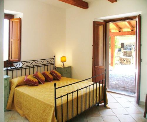 a bedroom with a bed and a sliding glass door at Torre Russo in Guardavalle