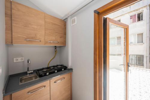 a small kitchen with a sink and a window at TAKSİM SUİTE in Istanbul