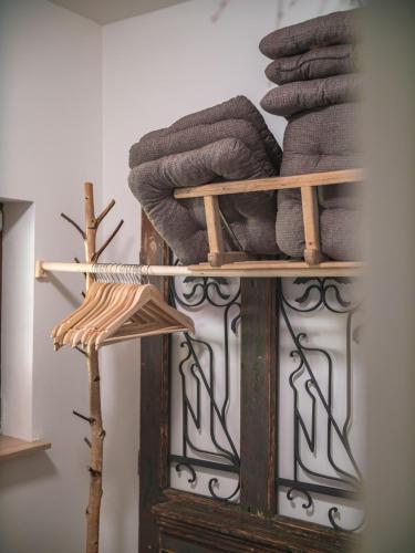 a wooden shelf with a pile of gray towels at Chalupa U potůčku in Velké Losiny