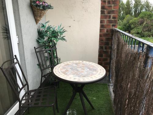 a table and two chairs on a balcony at Acorn Guest House in Hull in Hull
