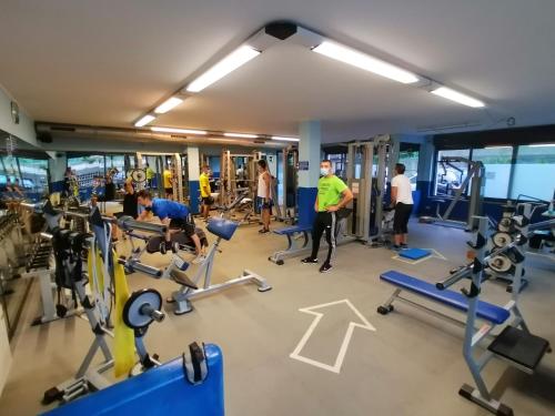 a group of people in a gym with machines at Hotel Rezia Valtellina in Morbegno