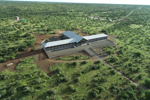 an aerial view of a building in the middle of a field at Big Valley Game Lodge in Lobatse