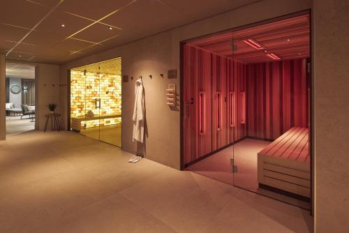 a dressing room with red cabinets and a red bench at Van der Valk Hotel Haarlem in Haarlem