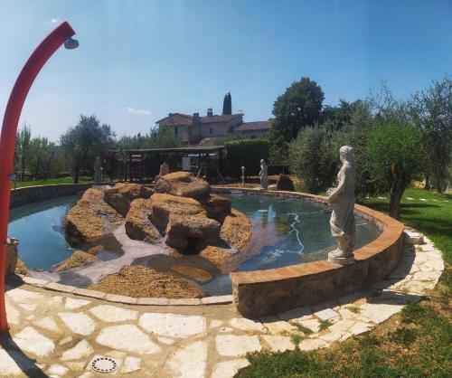 a fountain with a statue in a park at Tenuta Decimo - Villa Dini in San Gimignano