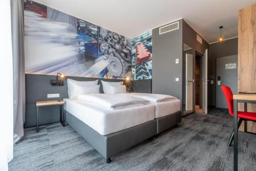 a bedroom with a large white bed and a desk at Aiden by Best Western Stadtgut Hotel Steyr - FREE PARKING in Steyr