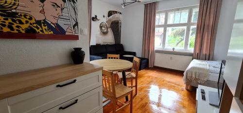 a kitchen with a table and a dining room at Apartamenty EverySky - Konstytucji 3 go Maja 66-2 in Karpacz