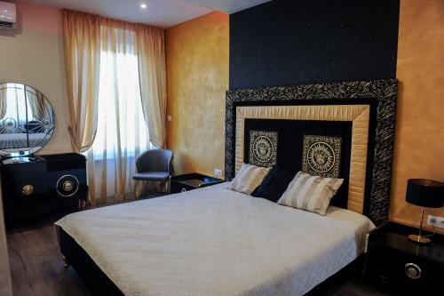 a bedroom with a large bed and a window at Apartmani President I in Banja Luka