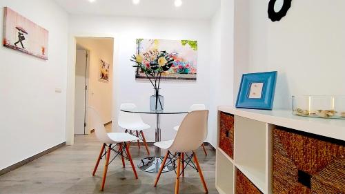 a dining room with a table and chairs at BEACH&GARDEN in Málaga