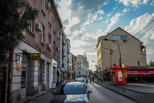 a car parked on a city street with buildings at Apartmani President I in Banja Luka
