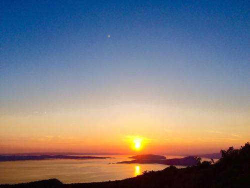 a sunset over a body of water at Apartment Modric in Senj