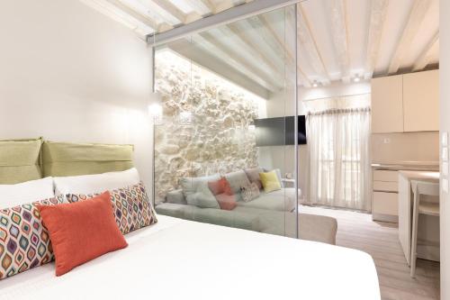 a bedroom with a white bed and a couch at Spianada Collection of Studios & Apartments by Konnect in Corfu Town