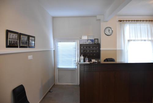 a kitchen with a counter and a clock on the wall at Parissas Hotel in Tsotílion