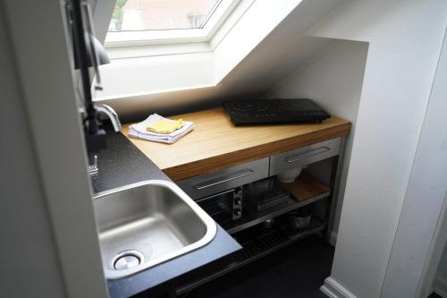 a small kitchen with a sink and a window at Homely 2 room Apartment close to Copenhagen city center in Copenhagen