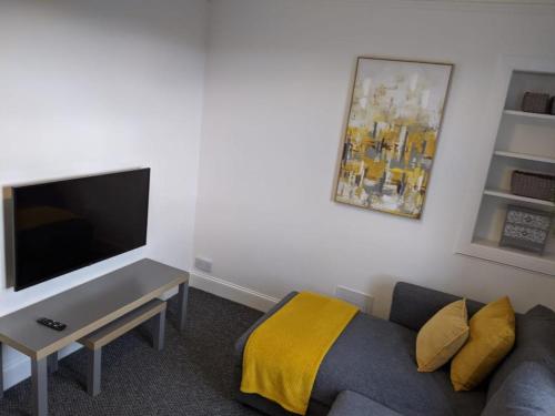 a living room with a couch and a flat screen tv at 'No.5' Bellyeoman in Fife