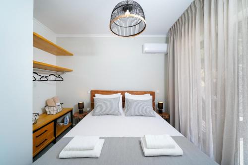 a bedroom with a large bed with two pillows at Videre Luxury Suites in Potos