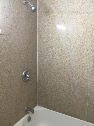 a shower with a glass door in a bathroom at Budget Inn Plainview in Plainview