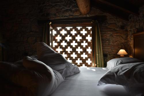 a bedroom with a bed with an american flag on the window at Cascina Belvedì in Clanezzo