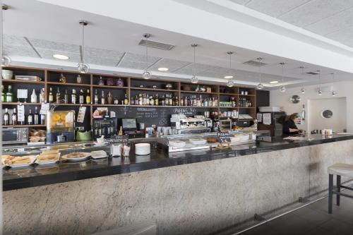 a bar in a restaurant with a counter with food at Hotel Plazaola in Irurtzun