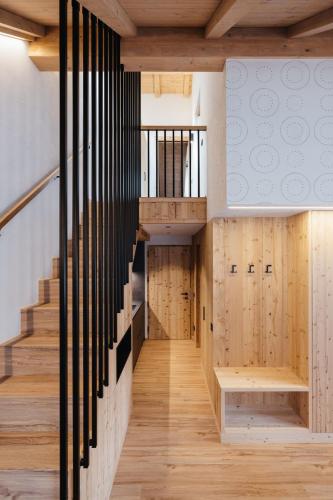 a staircase in a house with wood paneling at Alpine Chalet Sauter in San Vigilio Di Marebbe
