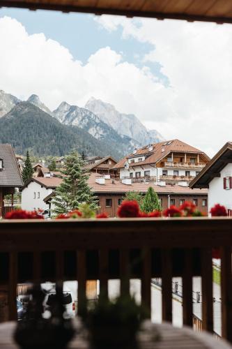 a view from a balcony of a town with mountains at Alpine Chalet Sauter in San Vigilio Di Marebbe