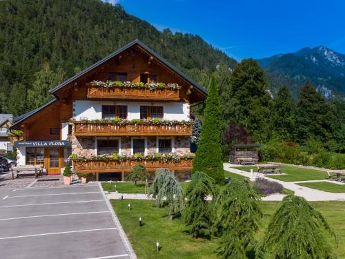 a building with flowers on the side of it at Apartments in Villa Flora in Kranjska Gora