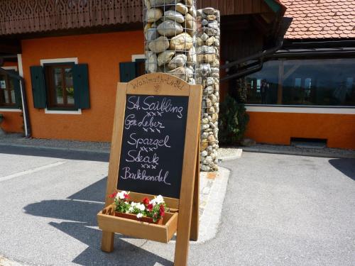 a chalkboard sign in front of a building at Wohlmuth-Lückl in Kitzeck im Sausal