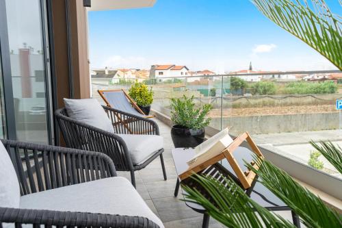 a balcony with chairs and a view of a city at Swell House in Ferrel
