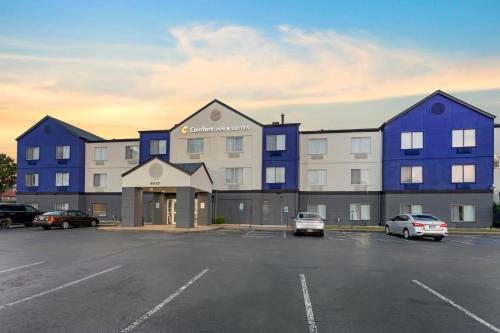 a large blue building in a parking lot at Comfort Inn & Suites Memphis East in Memphis