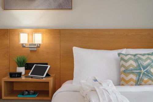 a bedroom with a bed with a laptop on a night stand at Radisson Beachfront Hotel - Panama City Beach in Panama City Beach