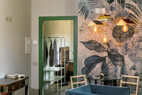 a room with a table and a wall with a mirror at Relais Cocci Grifoni - Panoramic Wine Resort in Offida