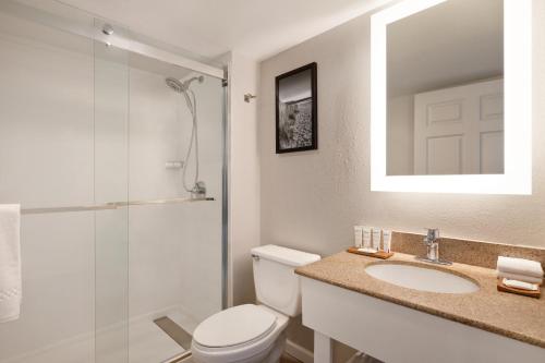 a bathroom with a toilet and a sink and a shower at Radisson Beachfront Hotel - Panama City Beach in Panama City Beach