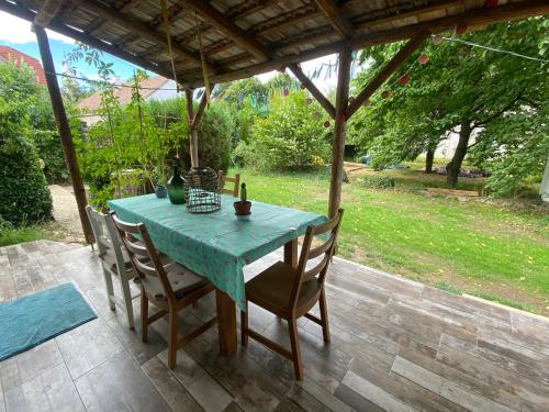 a blue table and chairs on a patio at Angel holiday appartman in Szentantalfa